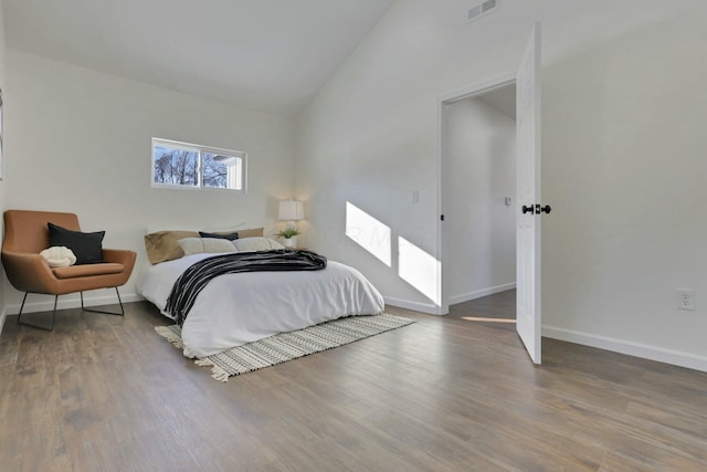 bedroom featuring wood-type flooring and vaulted ceiling