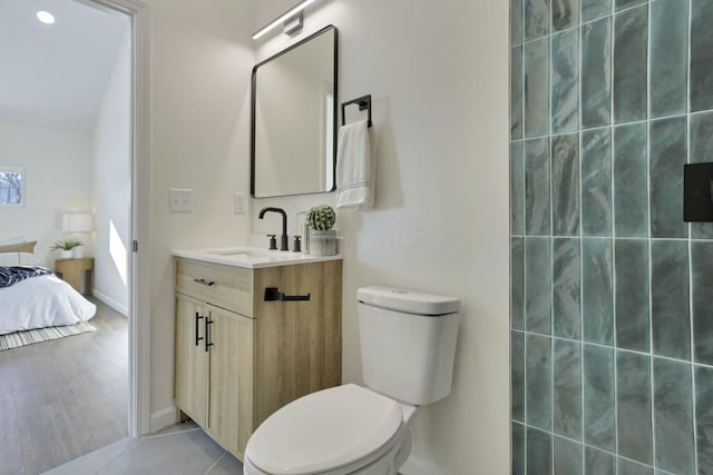 bathroom featuring vanity, tile patterned floors, and toilet