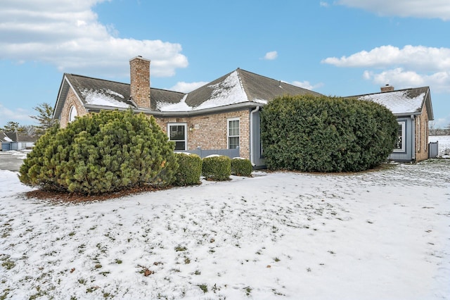 view of snow covered back of property