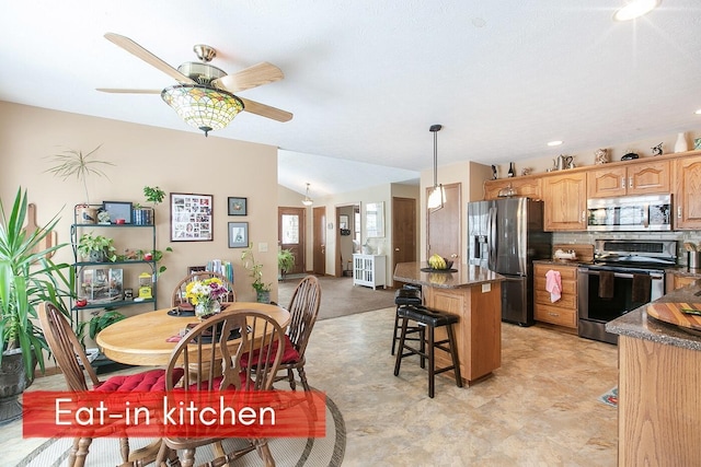 dining room featuring lofted ceiling and ceiling fan