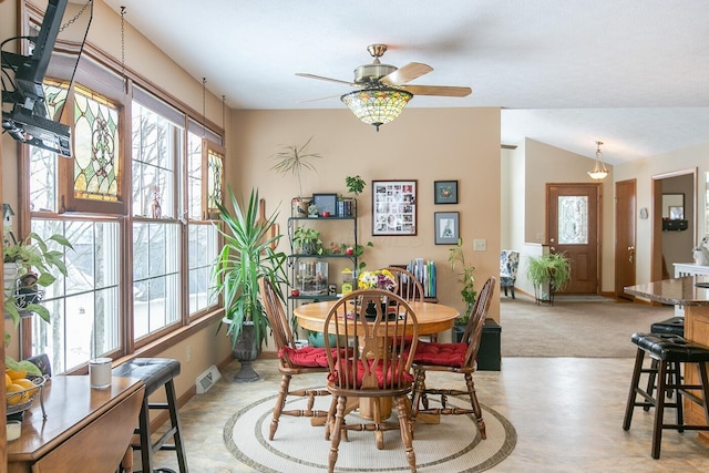 dining area featuring lofted ceiling and ceiling fan