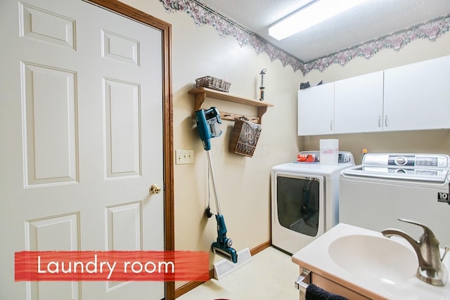 laundry room with cabinets, washer and clothes dryer, and sink