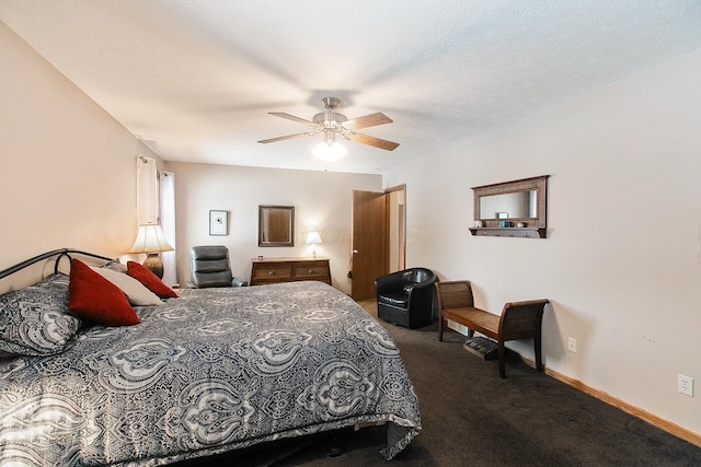 bedroom featuring ceiling fan, a textured ceiling, and dark colored carpet