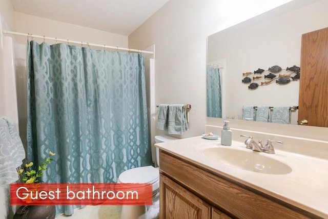 bathroom featuring vanity, toilet, and walk in shower