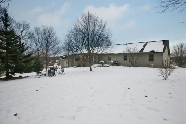 view of snow covered rear of property