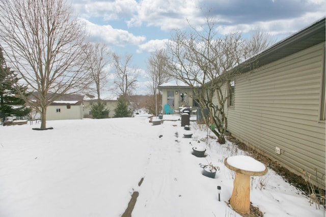 view of yard layered in snow