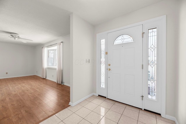 tiled entrance foyer featuring ceiling fan