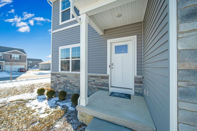 view of snow covered property entrance