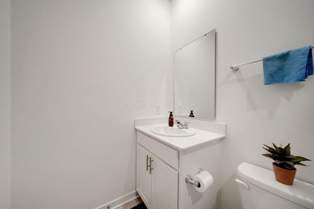 bathroom featuring toilet and vanity