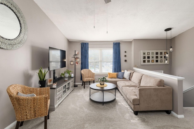 living room featuring a textured ceiling and carpet flooring