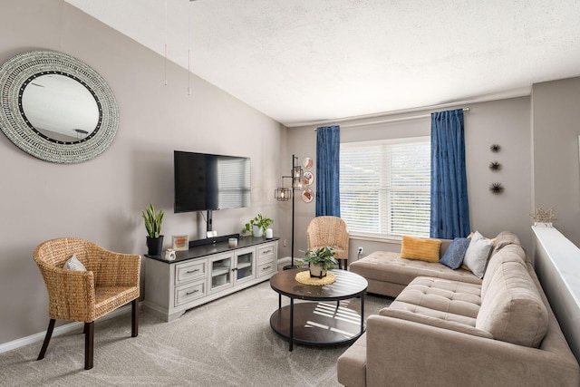 living room featuring vaulted ceiling, a textured ceiling, and light colored carpet