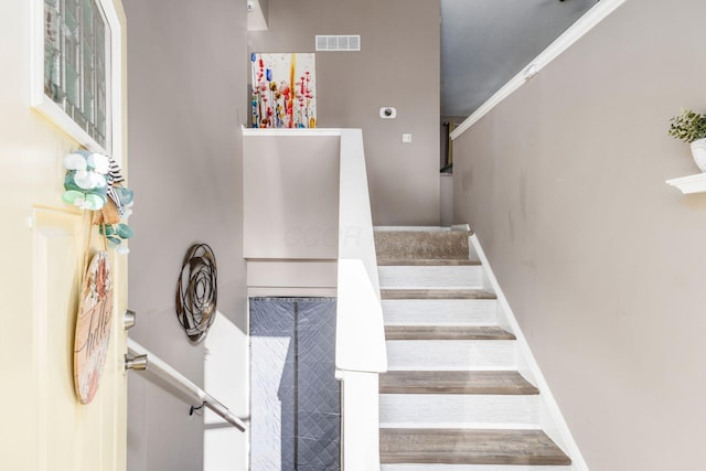 stairway featuring crown molding