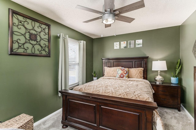 bedroom with light carpet, ceiling fan, and a textured ceiling