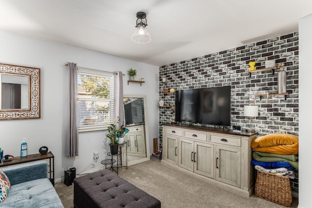 carpeted living room with brick wall