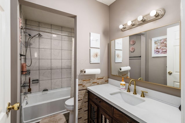 full bathroom featuring toilet, tiled shower / bath combo, and vanity