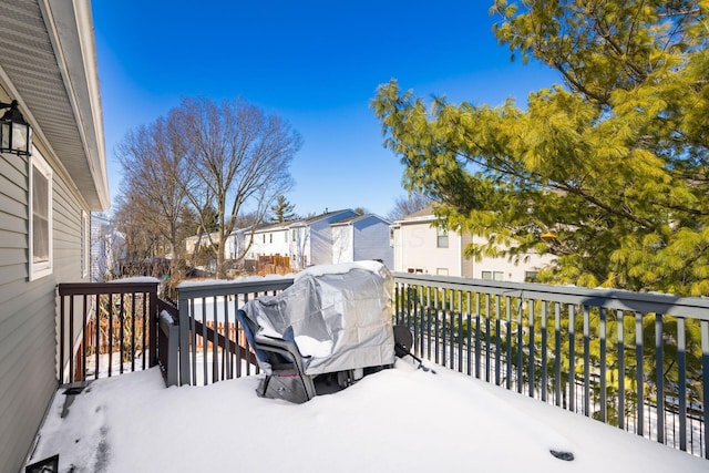 snow covered deck featuring a grill