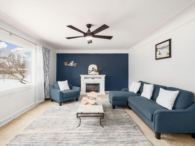 carpeted living room with crown molding and ceiling fan