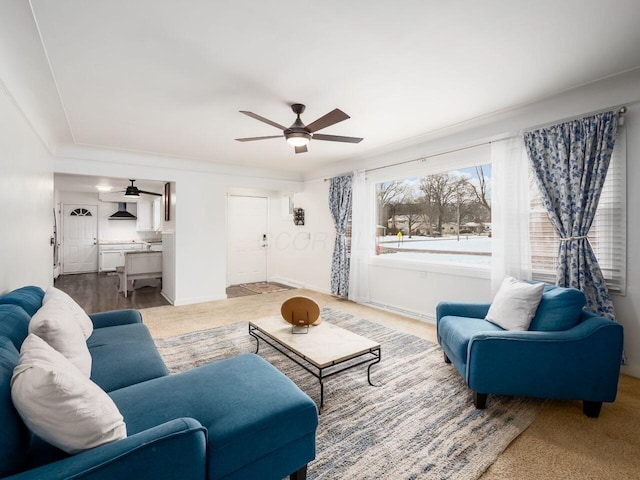 living room featuring ornamental molding and ceiling fan