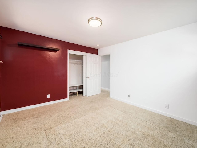 unfurnished bedroom with a closet and carpet