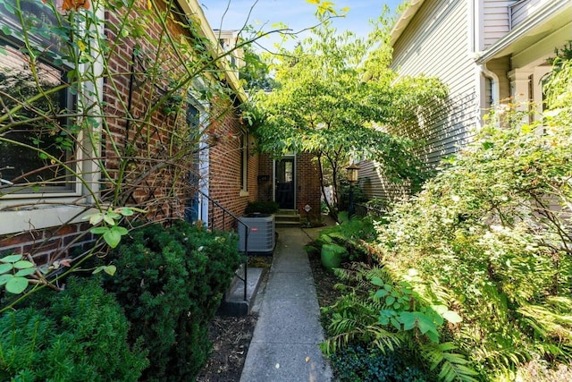 view of side of home with central AC unit