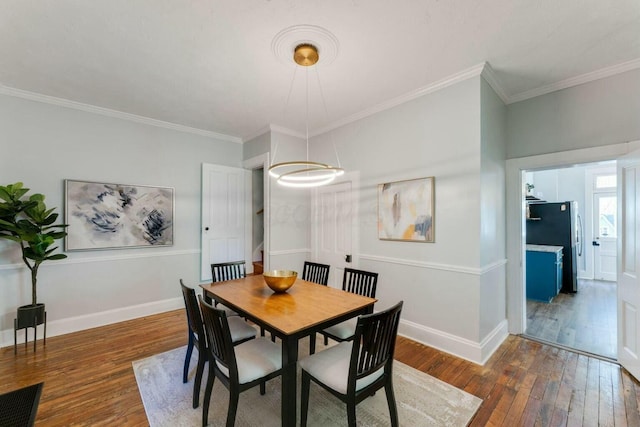 dining room with dark hardwood / wood-style floors and ornamental molding