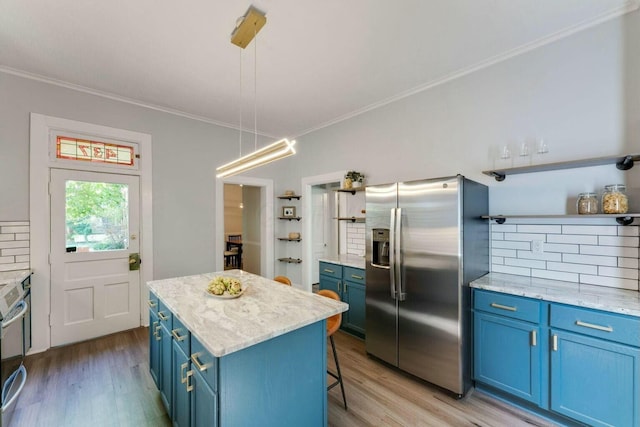 kitchen featuring blue cabinetry, pendant lighting, a center island, and stainless steel appliances