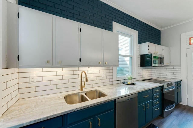 kitchen featuring light stone countertops, white cabinets, appliances with stainless steel finishes, sink, and blue cabinets