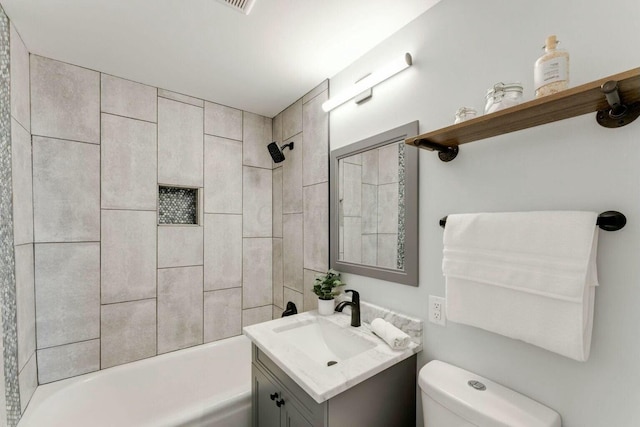 full bathroom with toilet, vanity, and tiled shower / bath combo