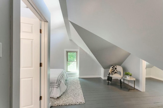 bedroom with wood-type flooring and lofted ceiling