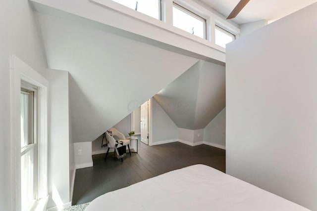 bedroom featuring dark wood-type flooring, lofted ceiling, and ceiling fan