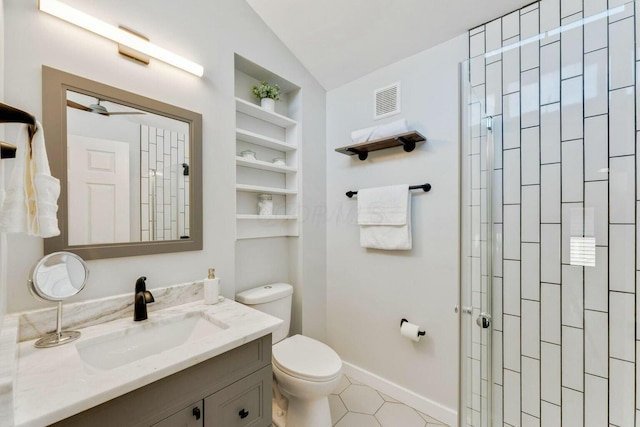 bathroom featuring tile patterned flooring, built in shelves, vanity, toilet, and vaulted ceiling