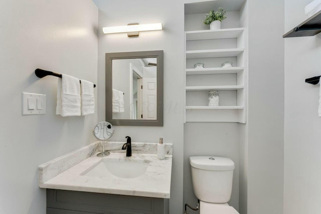 bathroom with toilet and vanity