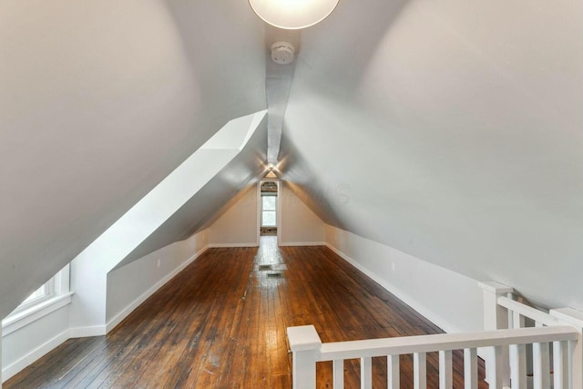 bonus room with dark wood-type flooring and lofted ceiling