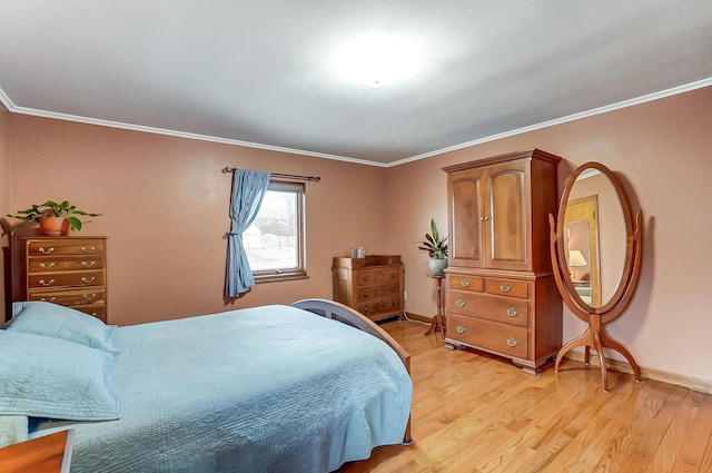 bedroom featuring ornamental molding and light hardwood / wood-style floors