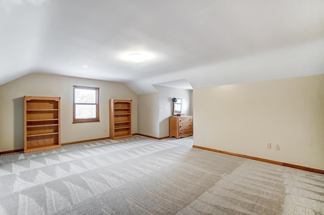 bonus room featuring vaulted ceiling and light colored carpet