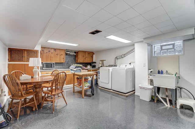 clothes washing area with washer and clothes dryer