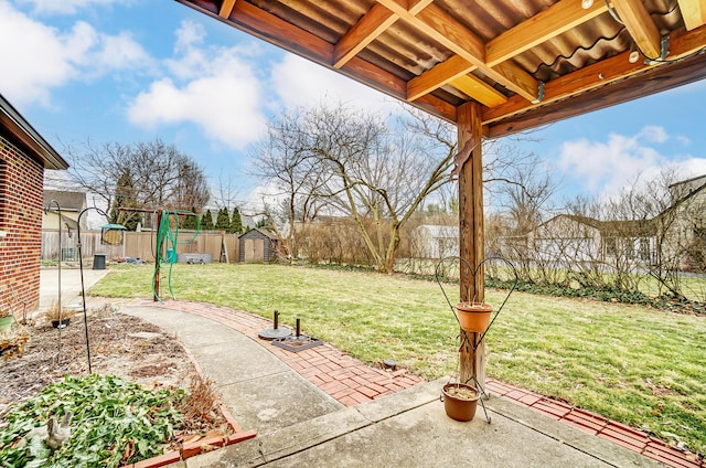 view of yard featuring a storage shed and a patio