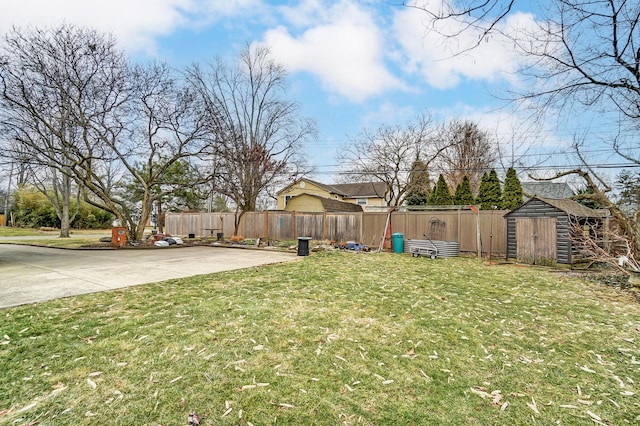 view of yard with a storage shed and a patio