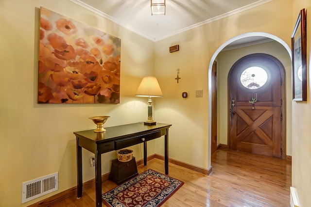 entrance foyer featuring light hardwood / wood-style flooring and ornamental molding