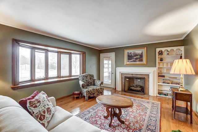 living room featuring ornamental molding and light hardwood / wood-style floors