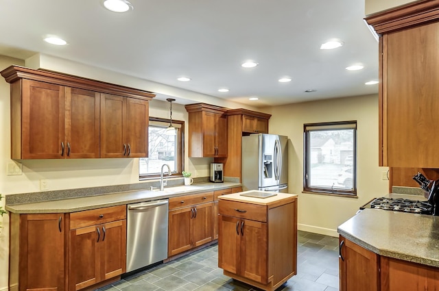 kitchen featuring sink, hanging light fixtures, and appliances with stainless steel finishes