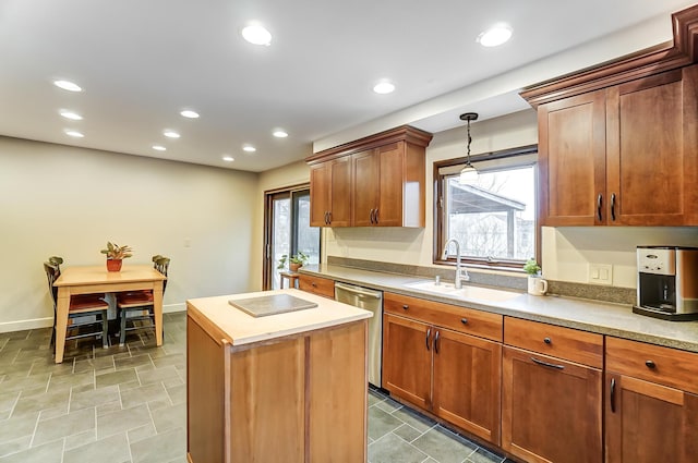 kitchen featuring sink, stainless steel dishwasher, hanging light fixtures, and a center island