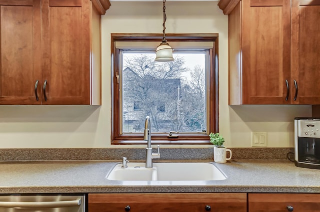 kitchen featuring pendant lighting, sink, and dishwasher