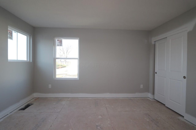 unfurnished bedroom with multiple windows