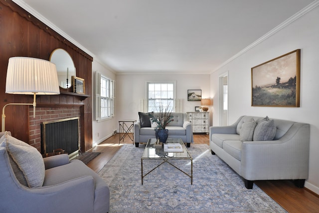 living room with wood-type flooring, a fireplace, and ornamental molding