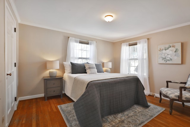 bedroom with crown molding, dark wood-type flooring, and multiple windows