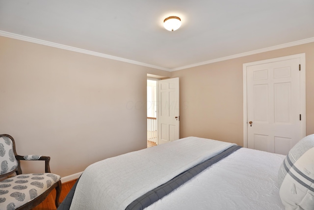 bedroom featuring crown molding and wood-type flooring