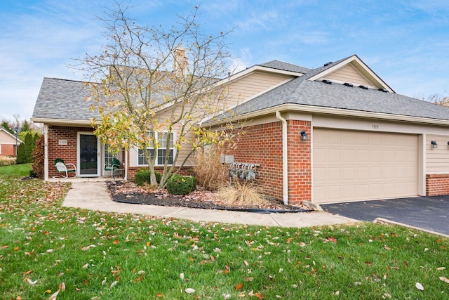 view of front of home featuring a garage and a front yard