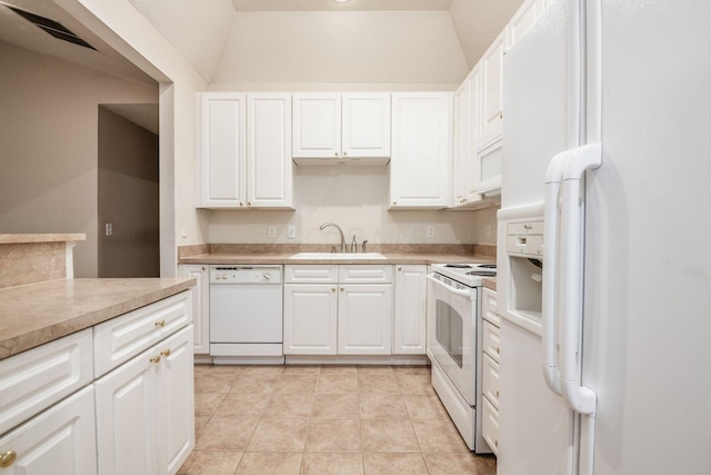 kitchen with lofted ceiling, white appliances, and white cabinetry