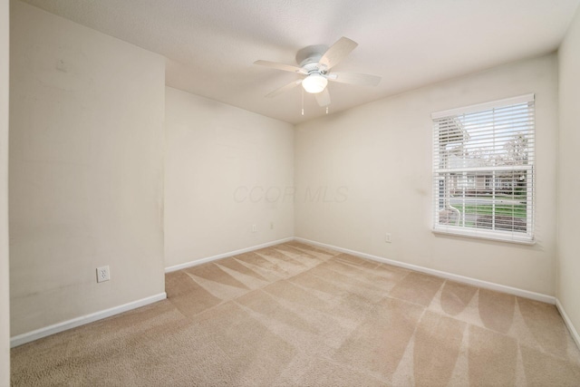 unfurnished room featuring light carpet and ceiling fan